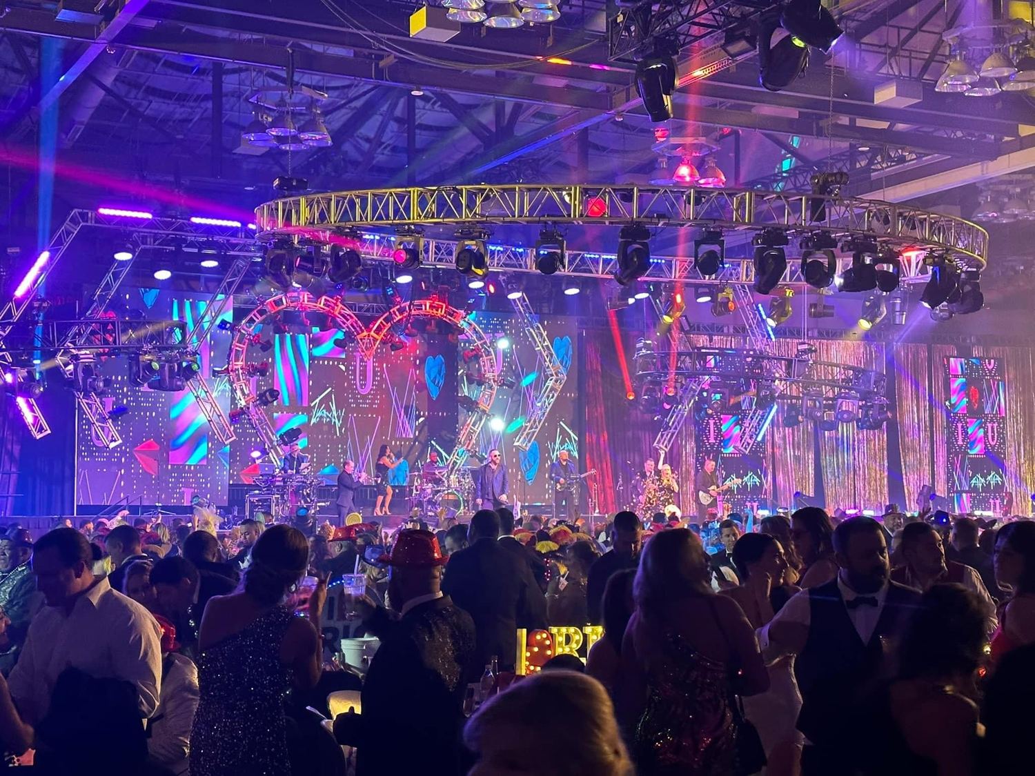 Sugar Shaker performing under a full circular lighting truss at a black-tie ball in New Orleans